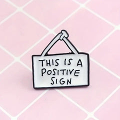 Positive sign enamel pin