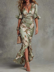 Anna - Asymmetrical long dress in green satin with V-neck. flared puff sleeves. and floral pattern
