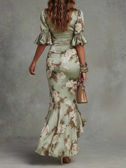 Anna - Asymmetrical long dress in green satin with V-neck. flared puff sleeves. and floral pattern