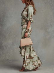 Anna - Asymmetrical long dress in green satin with V-neck. flared puff sleeves. and floral pattern